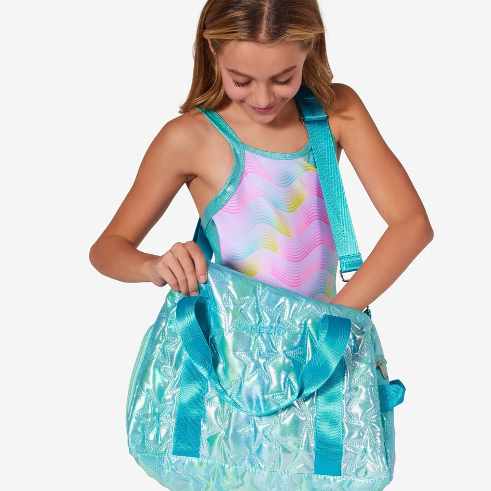 
                      
                        Girl holding a large turquoise bag with a white background
                      
                    
