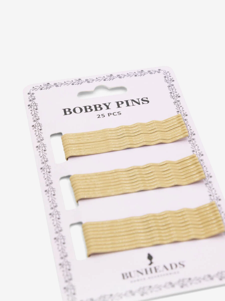 
                      
                        A single sleeve of 25 blonde bobby pins lays at an angle against a plain background with the words BOBBY PINS and BUNHEADS on the package.
                      
                    
