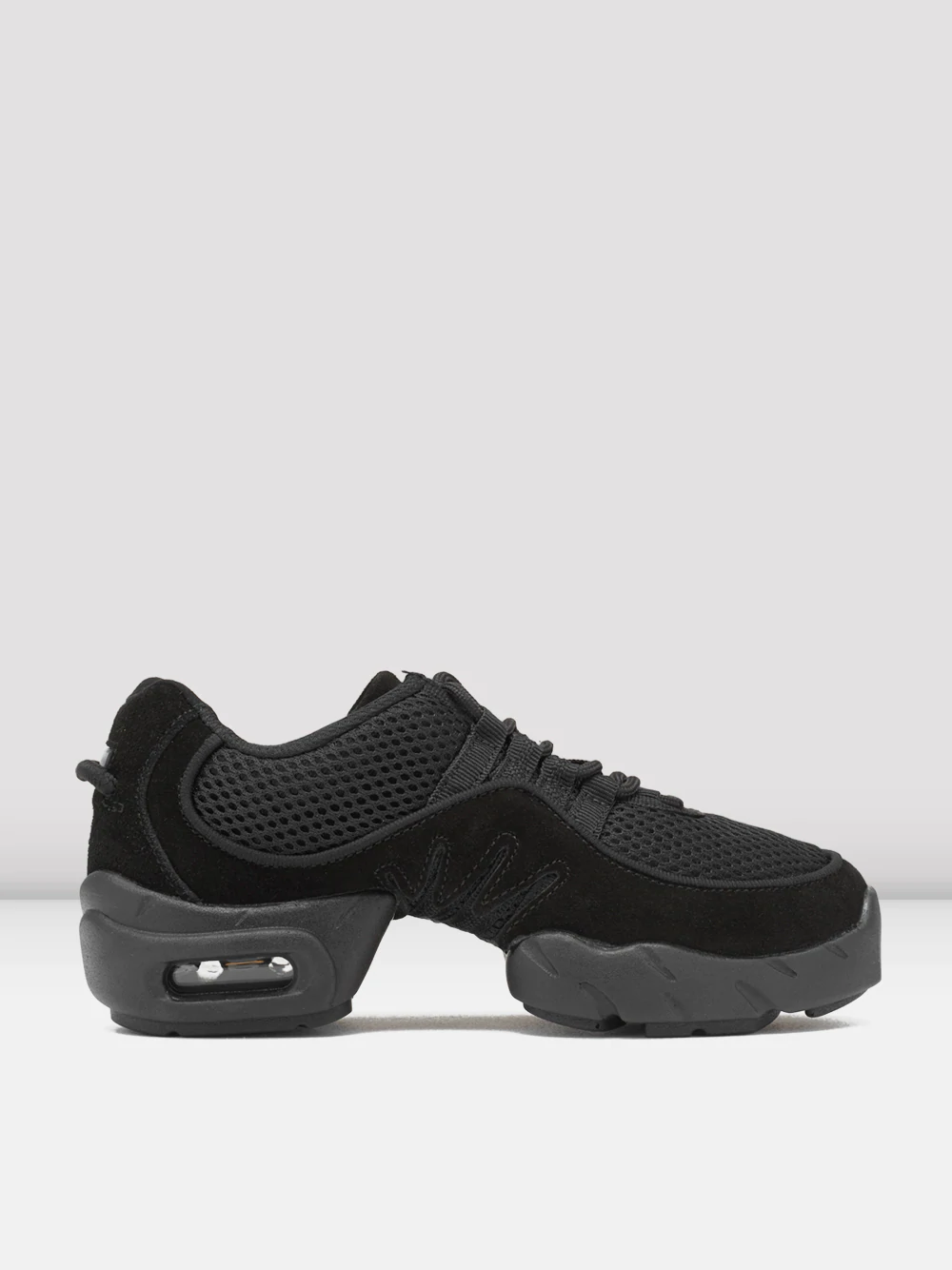 Side view of a pair of black sneakers with mesh and suede textures. The shoes feature a thick, cushioned split-sole. Light grey, plain background.