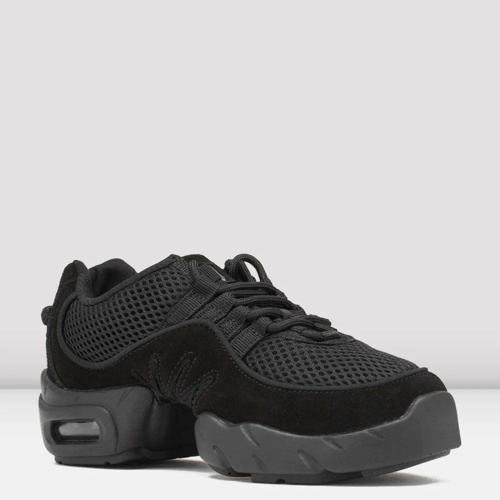 A pair of black sneakers with mesh and suede textures. The shoes feature a thick, cushioned sole with visible air pockets in the heel for added comfort. Matching black laces are tied on top, and the background is a plain, light grey.