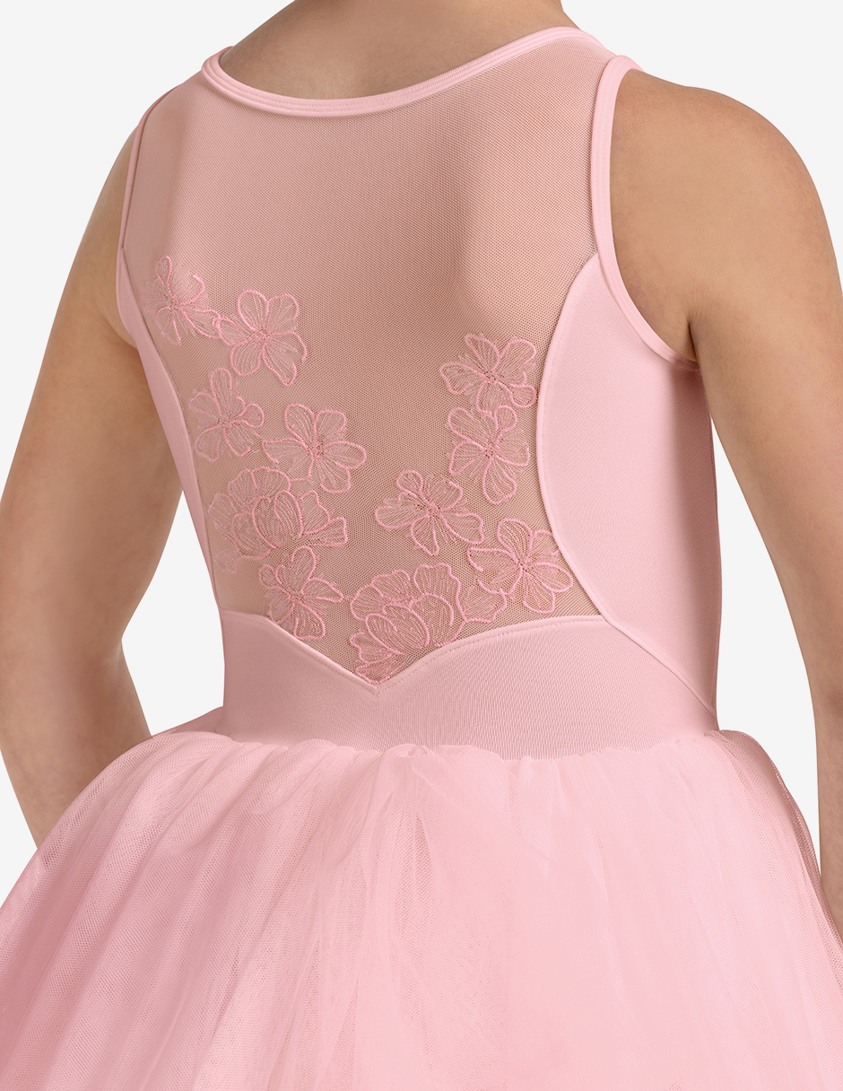 Pink dress with floral lace detailing on a plain background