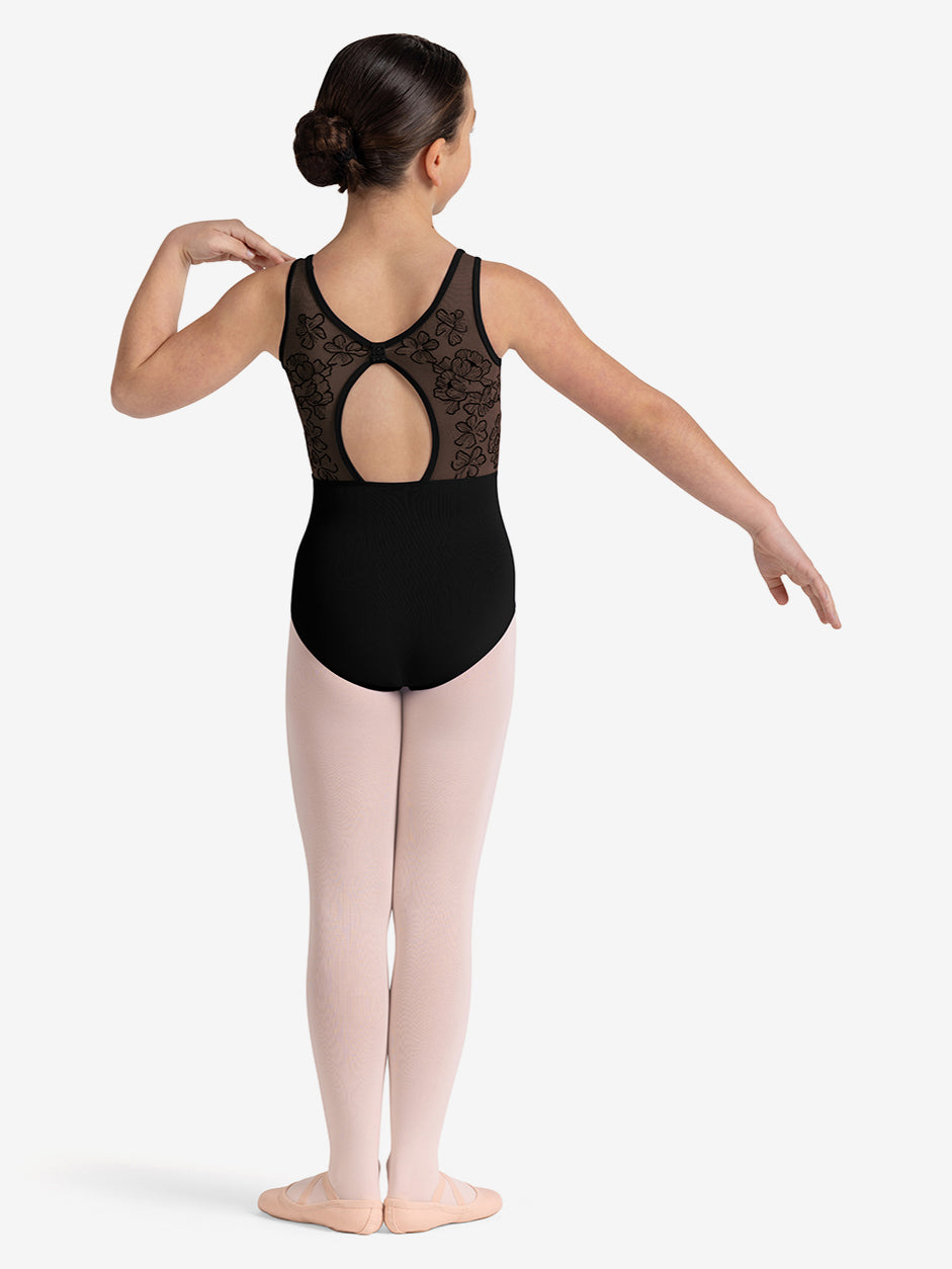 Ballerina in a black leotard with lace detailing and pink tights on a white background