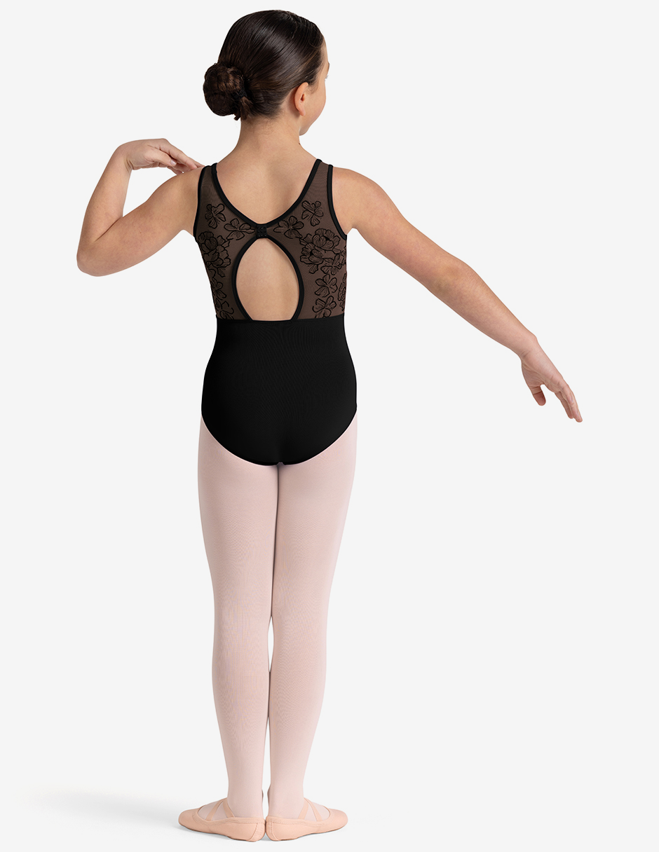 Ballerina in a black leotard with lace detailing and pink tights on a white background