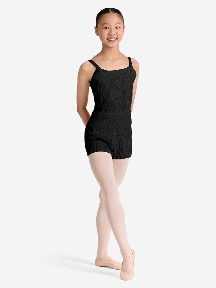 
                      
                        Young girl wearing a black unitard on a white background
                      
                    