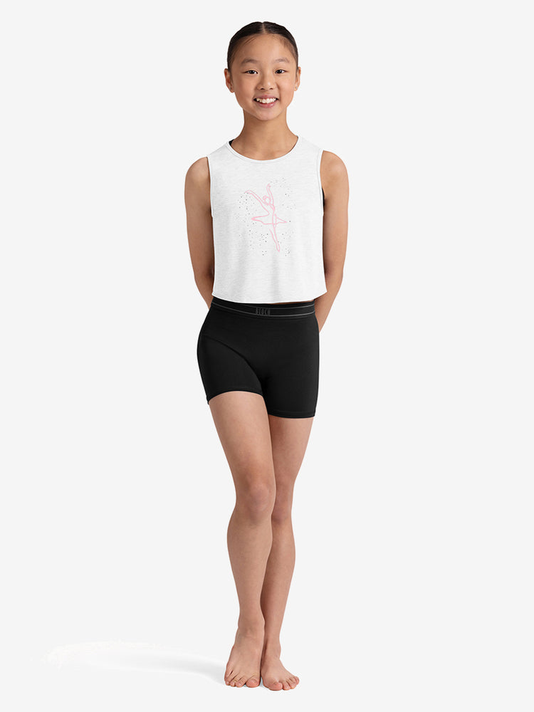 Young girl wearing a white sleeveless top and black shorts on a white background