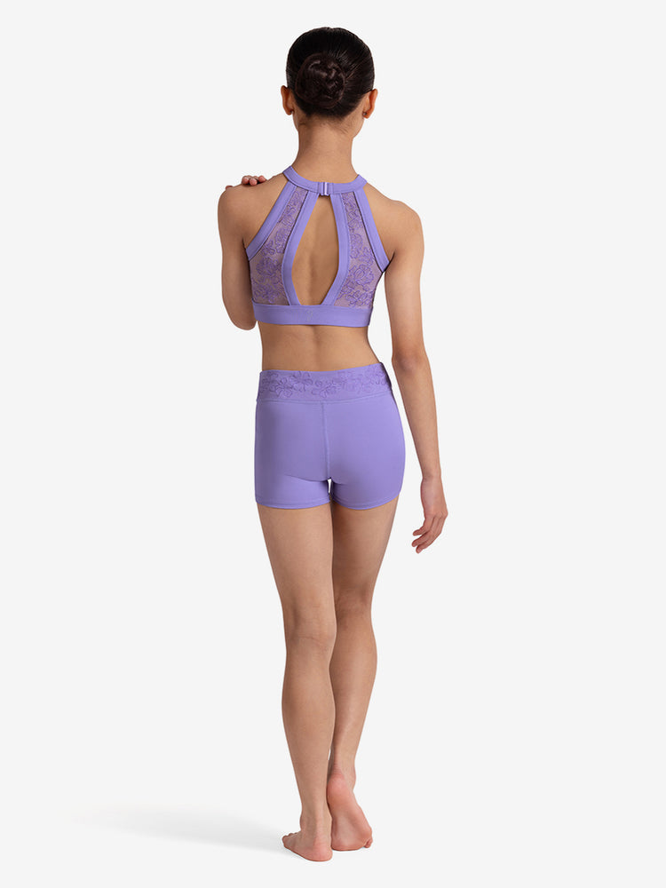 
                      
                        Girl wearing a lilac lace top and shorts on a white background
                      
                    