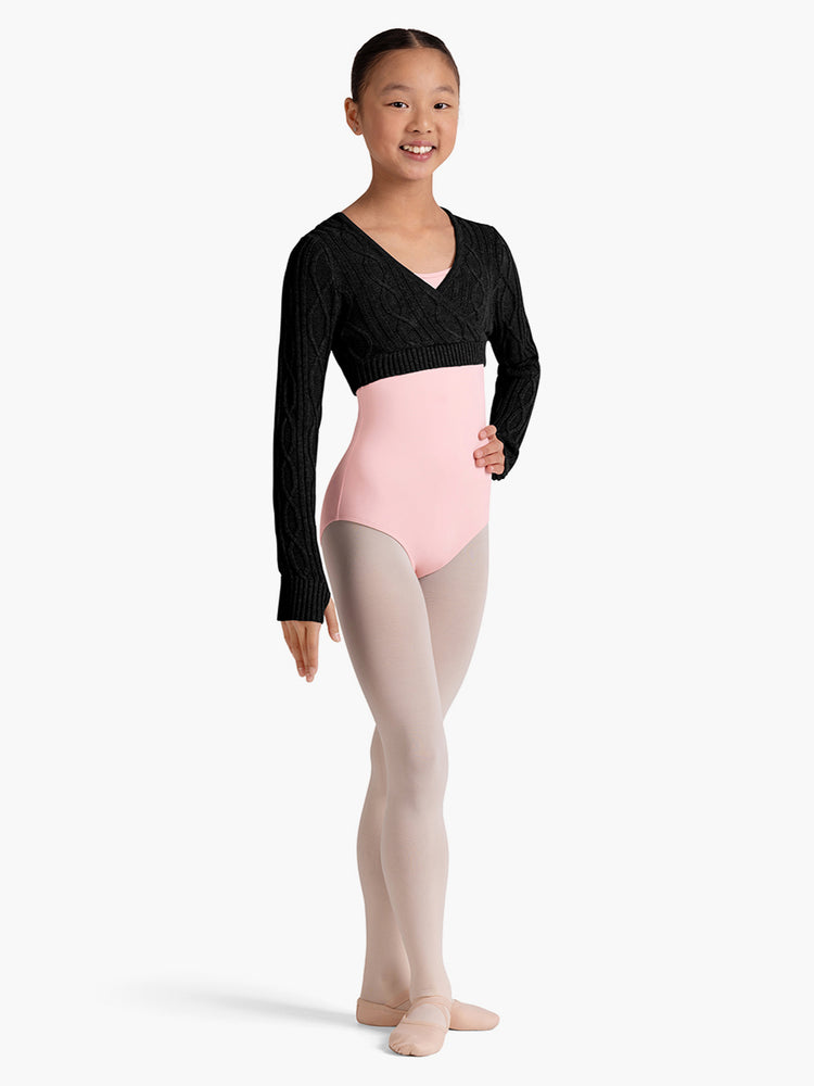 
                      
                        Young dancer wearing a black long-sleeve crop top, pink leotard, and pink tights on a white background
                      
                    
