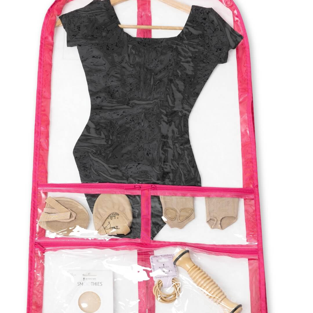 A Clear Capezio Garment Bag with Pink Trim Hanging from a Wooden Handle. The Bag Contains a Leotard and Various Other Dance Accessories.