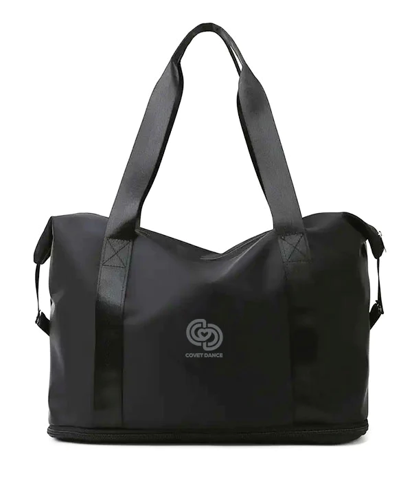 Joi Studio Tote Bag By Covet Dance. A Black Expandable Bag. Image of Bag With Strap Raised. 