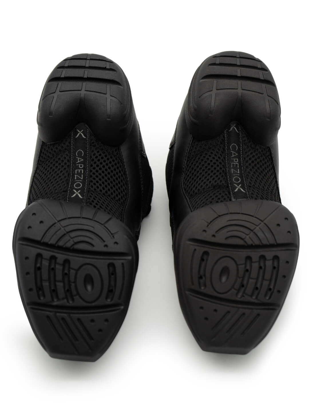 The bottom of a pair of dance sneakers, split-sole, showcasing the turn pads, dance rubber, and Capezio logo across the middle