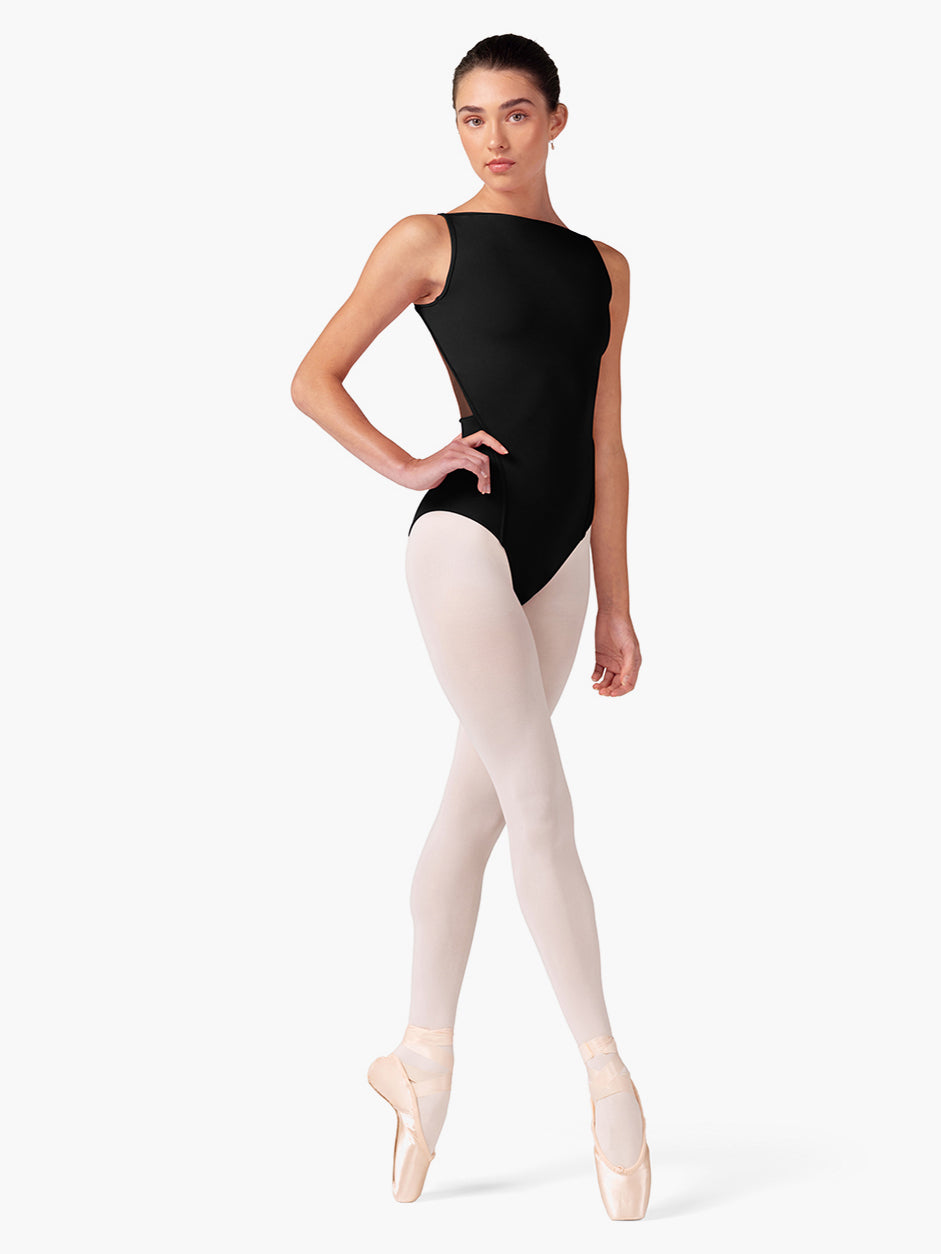 Woman wearing a black leotard and pink tights on a white background