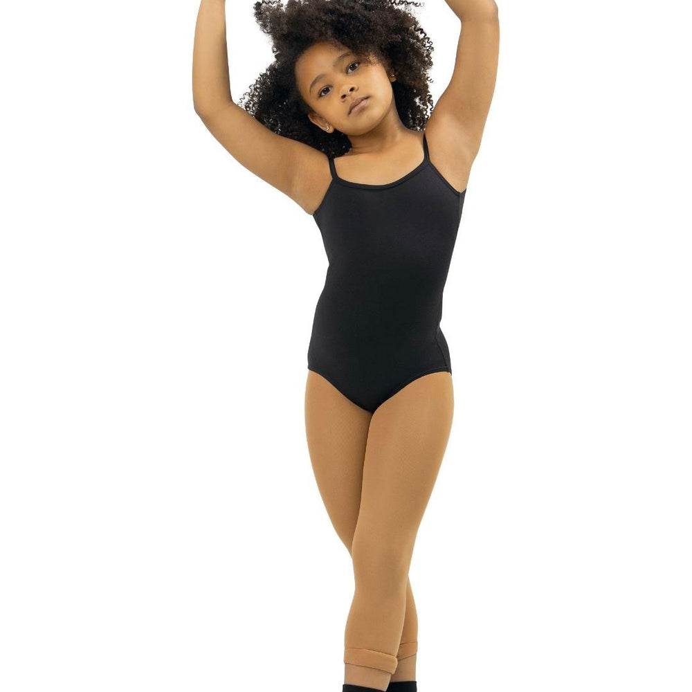A young girl in a ballet pose. She is wearing a black leotard, light brown skintone tights, and black dance socks. Her arms are raised above her head, and she stands in fifth position. She has curly hair and a focused expression.