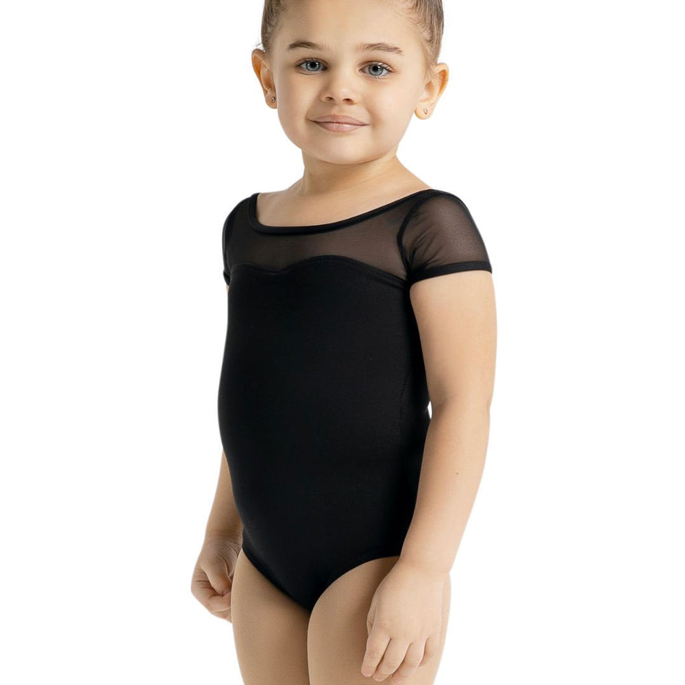 
                      
                        A small child with a top knot bun stands sweetly in a black short sleeve leotard.
                      
                    