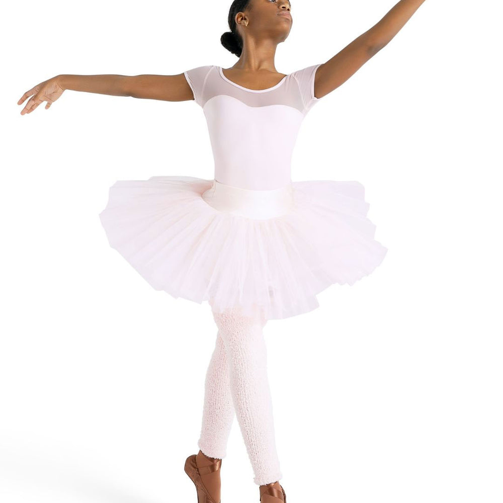 
                      
                        A ballerina dressed in a light pink leotard and tutu stands en pointe with her arms gracefully extended. She wears skintone pointe shoes. Her hair is neatly tied back, and she gazes upward with a poised, elegant expression.
                      
                    