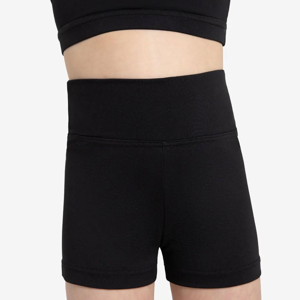 
                      
                        A close-up of a child's torso wearing a black crop top and high waisted, black shorts
                      
                    