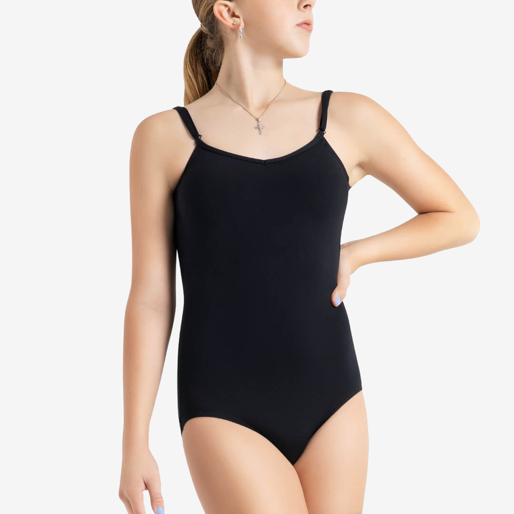 
                      
                        A young dancer with painted blue nails and one hand on her waist gazes up toward the right. She wears a black, spaghetti strap leotard and nude leggings, along with a necklace and earrings. She has blonde hair pulled into a ponytail.
                      
                    