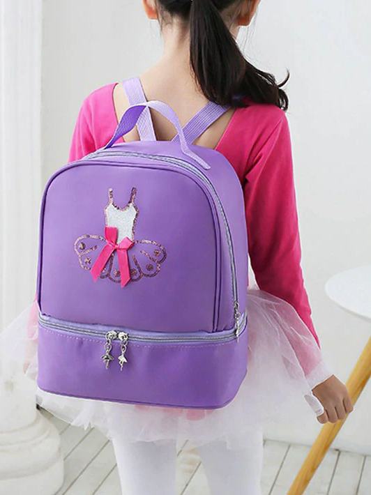 
                      
                        Little Girl Wears The Sparkly Tutu Backpack from Covet Dance is a Pretty Purple Backpack. On the Back a Dancer's Leotard in Sequins is Adorned with a Pink Ribbon. The Zippers Feature Cute Ballerina Charms that Dangle.
                      
                    