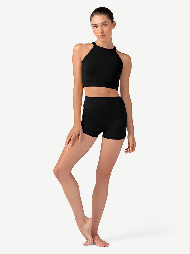 Woman wearing a black athletic outfit on a white background