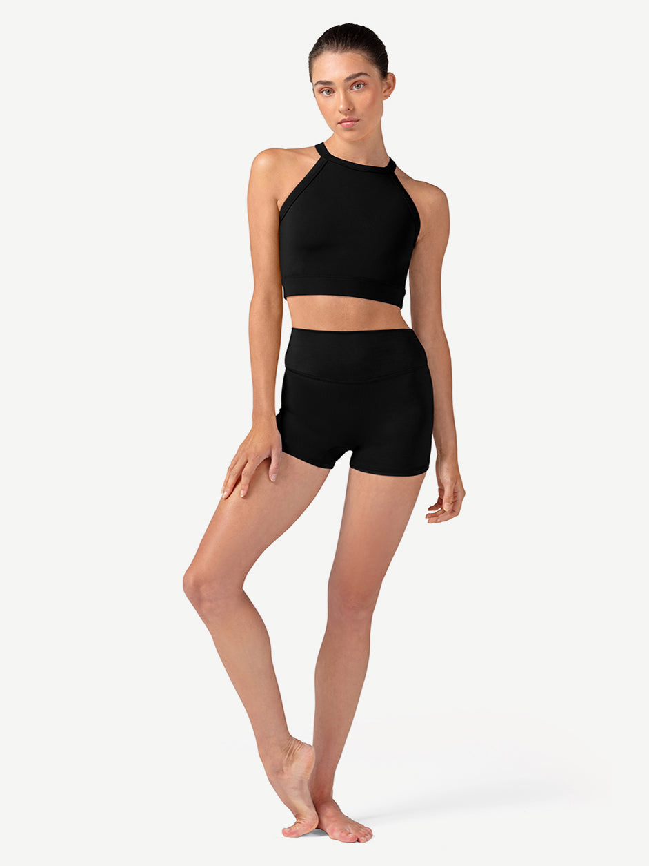 Woman wearing a black athletic outfit on a white background