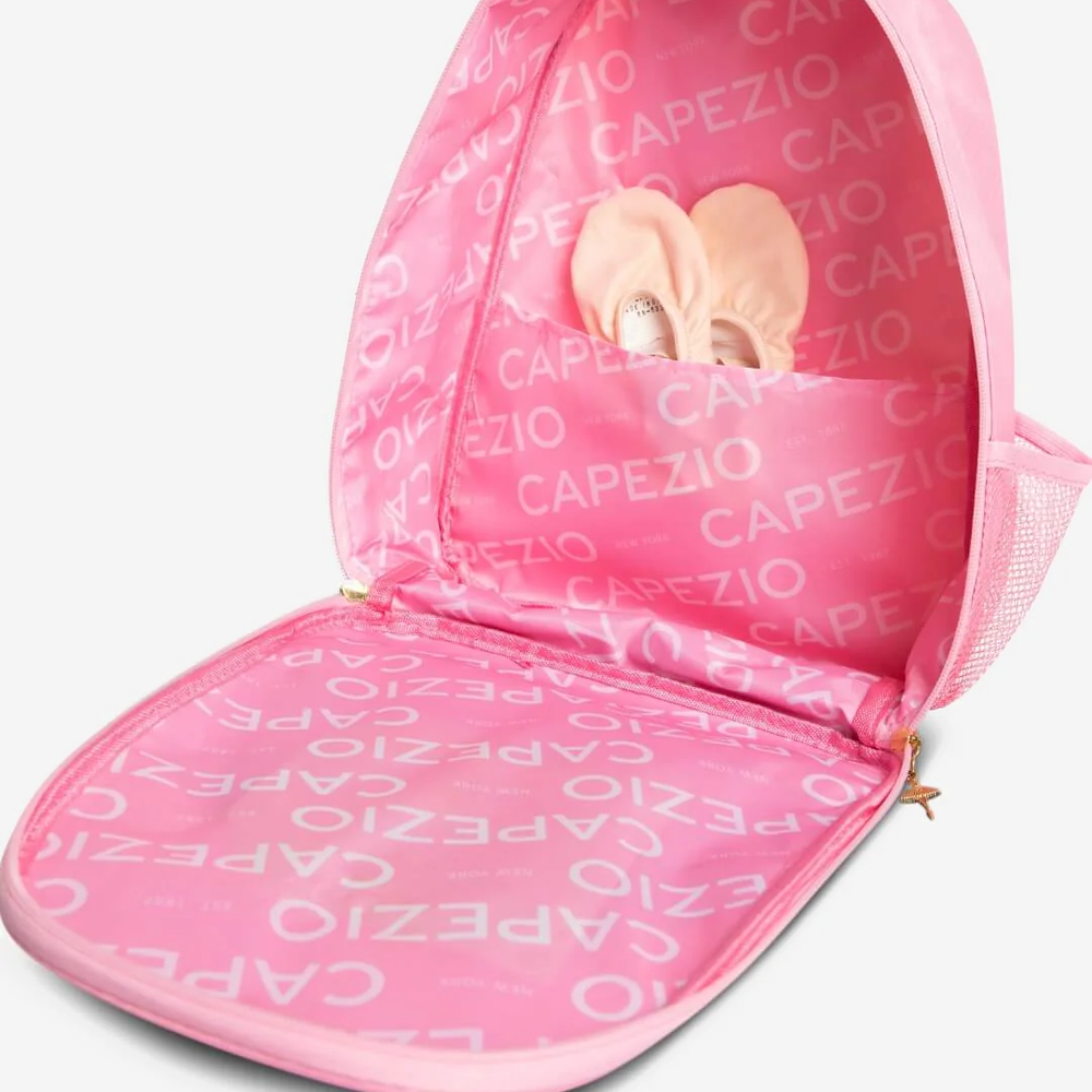 
                      
                        Pink dance backpack holding ballet shoes with 'Capezio' branding lining
                      
                    