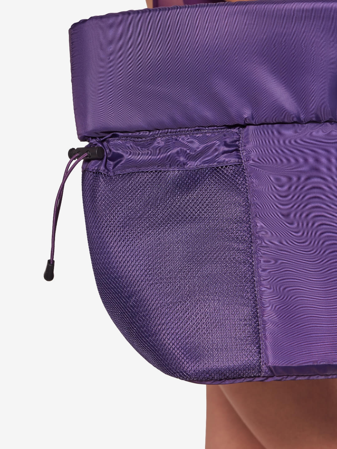 Close-up of a purple bag with a mesh sleeve on a white background