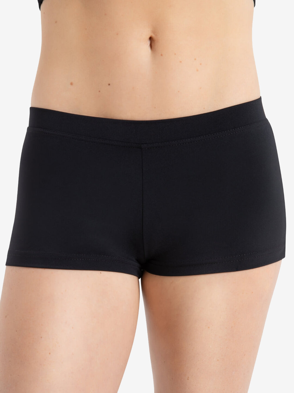 A person wearing a pair of black, fitted shorts is shown from the waist to the thighs. The background is plain and neutral.