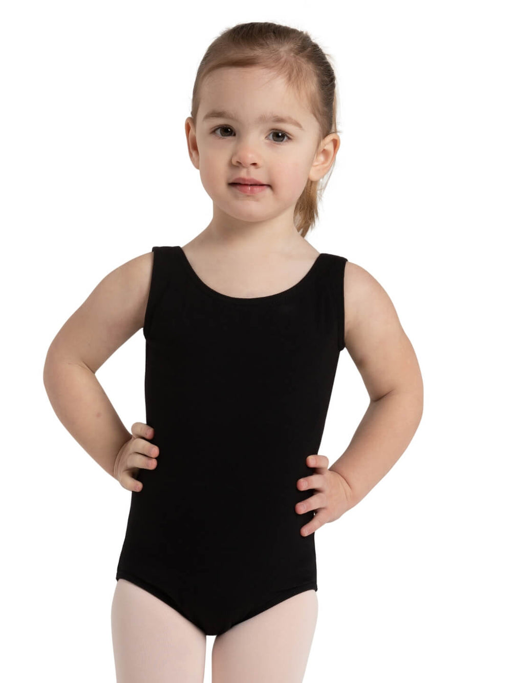 A small child stands, hands on her hips, wearing a tank style black leotard.
