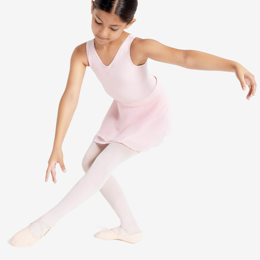 
                      
                        A young child extends her front leg forward and her arm to the side in a graceful ballet pose. She wears a tank style pink leotard, skirt, tights, and ballet shoes.
                      
                    