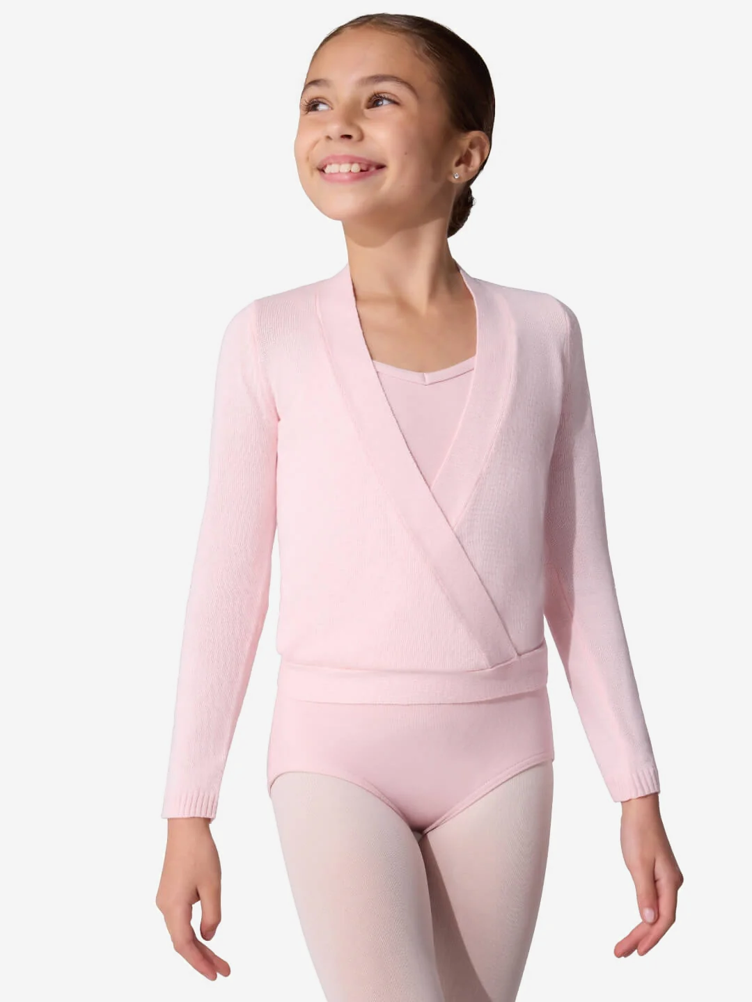 Young girl in a pink ballet outfit on a white background