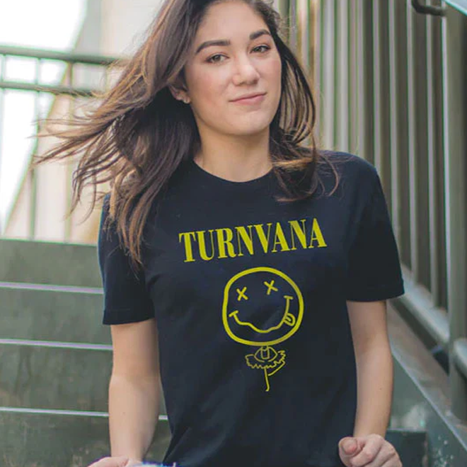 Person wearing a vintage rock grey t-shirt with 'TURNVANA' design outdoors.