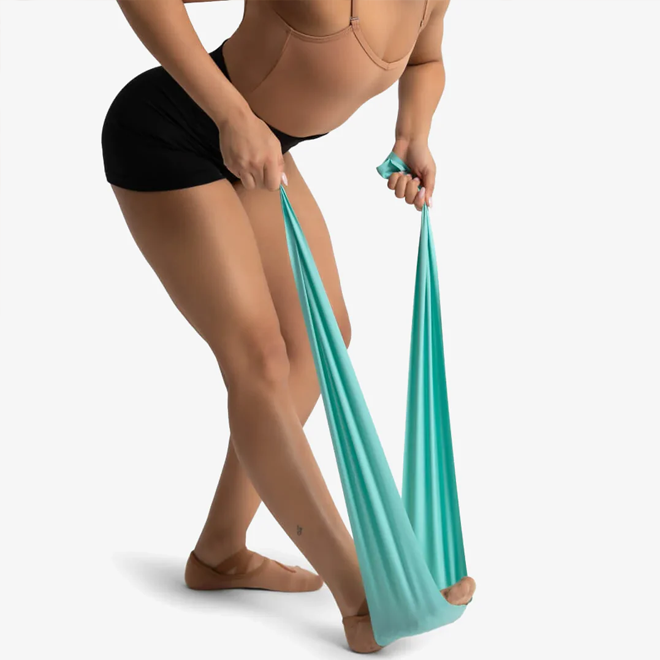 Person holding a teal resistance band against a white background