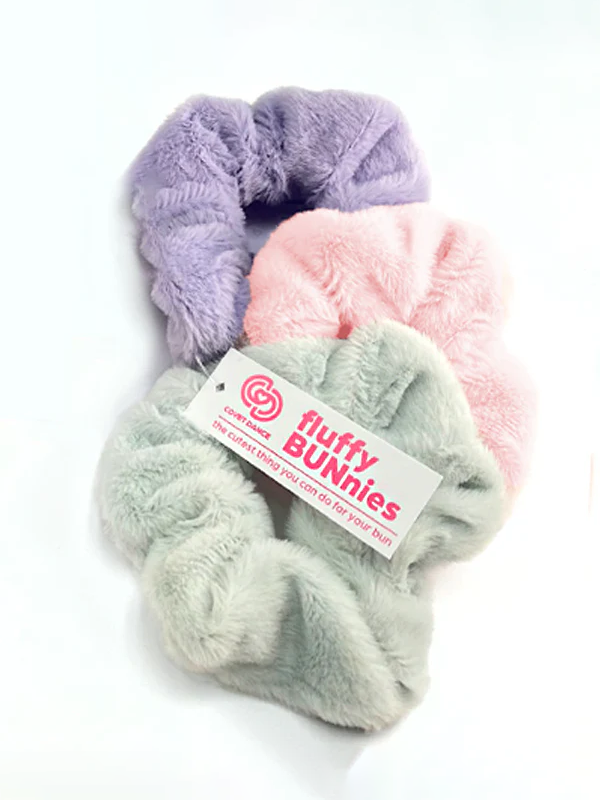 A set of three pastel colored, soft fluffy scrunchies, with a white tag with pink text reading fluffy BUNnies.