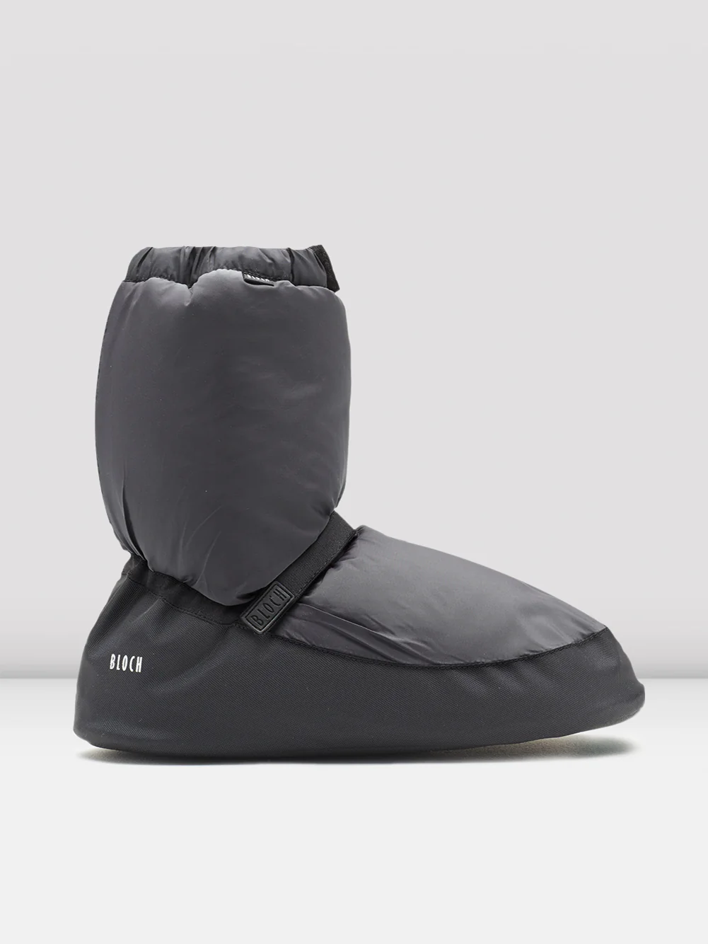 Gray slip-on booties with a brand logo on a grey background