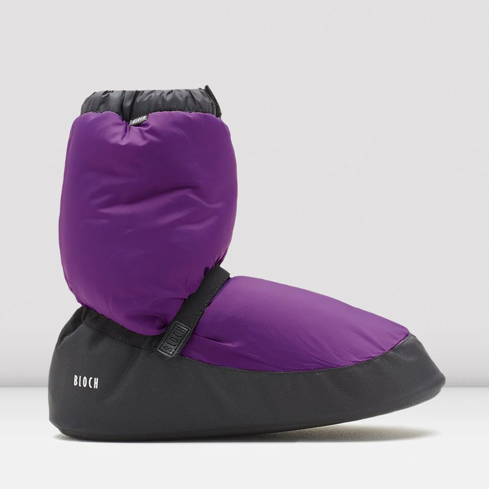 
                      
                        Purple and black booties with a visible brand logo on a grey background
                      
                    