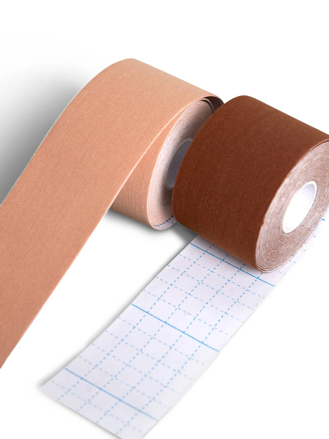 Two rolls of kinesiology tape side-by-side, a lighter nude is rolling over the top, a darker nude is rolling under the roll showing off the dividing lines for cutting.