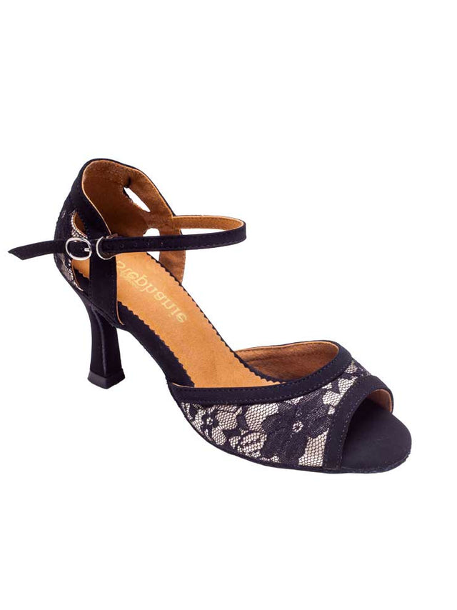 A single mid height, latin ballroom dance heel with tan insole and floral black lace over a hint of silver with black nubuck trim. Open toe, quick-release clasp. Plain white background.