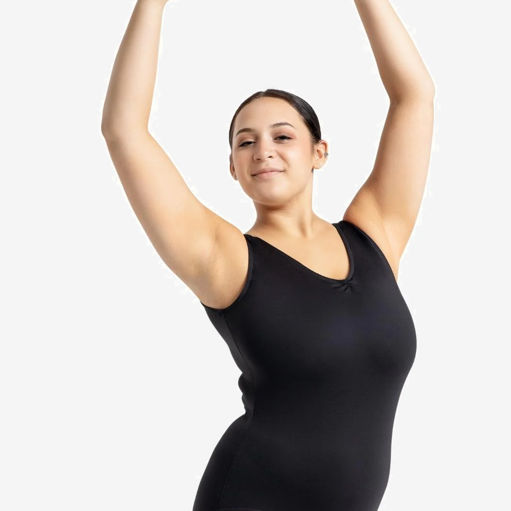 
                      
                        A female wearing a black leotard against a white background lifts her arms above her head
                      
                    
