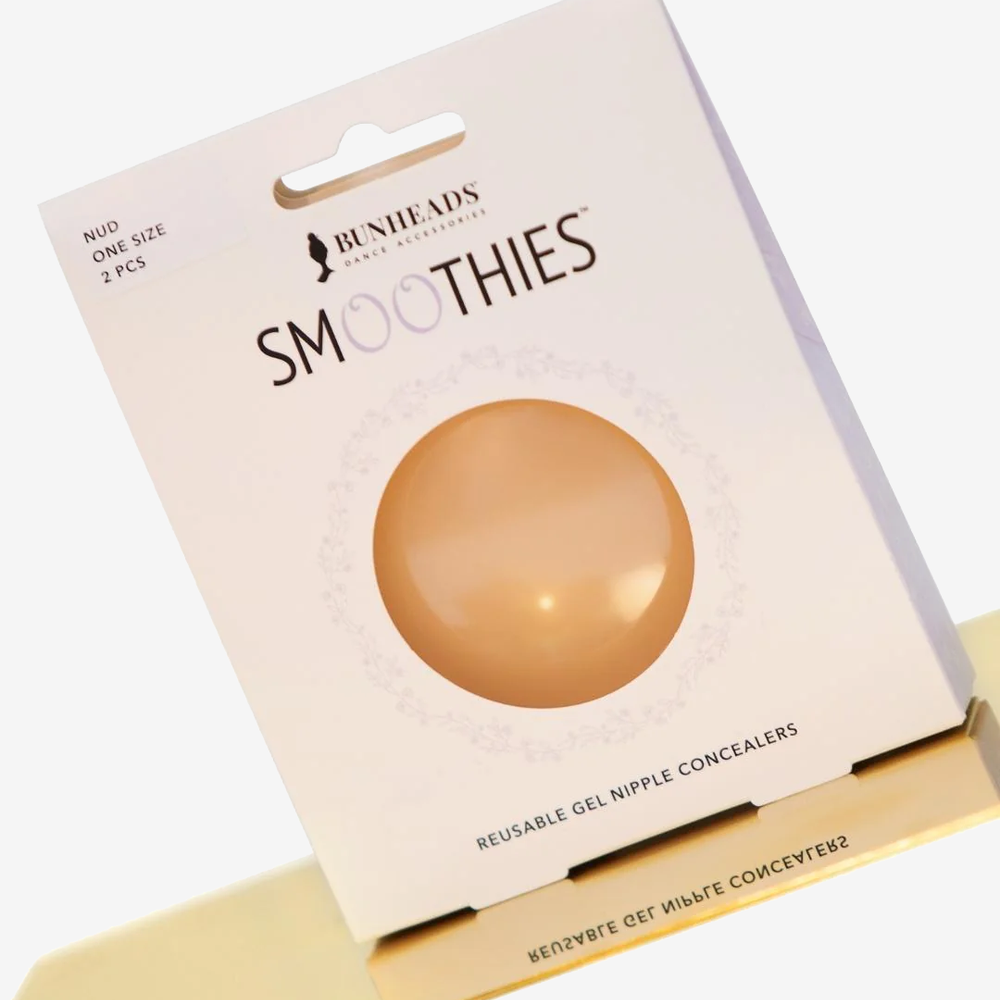
                      
                        A box of nude Bunheads Smoothies sits at an angle on a gold stand against a plain light grey background.
                      
                    