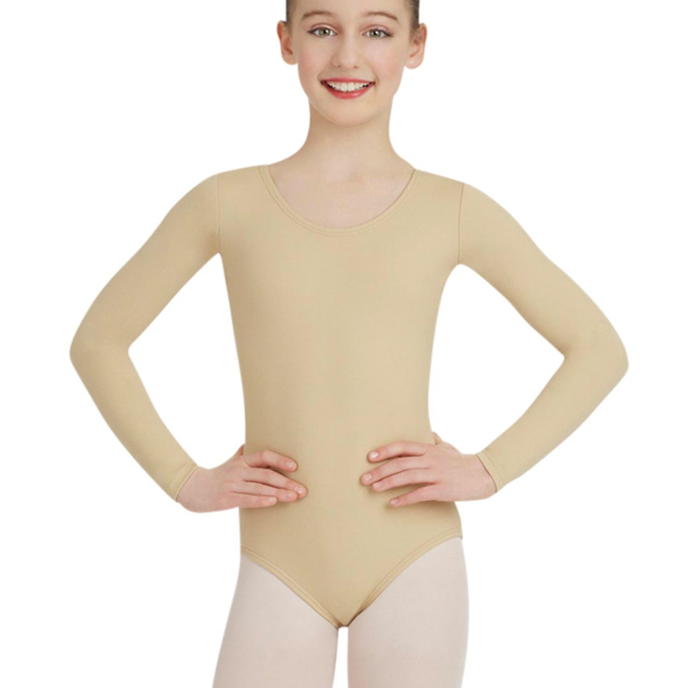 
                      
                        A young smiling girl with her hair slicked back wears a nude colored, long sleeve leotard and stands with her hands on her hips.
                      
                    