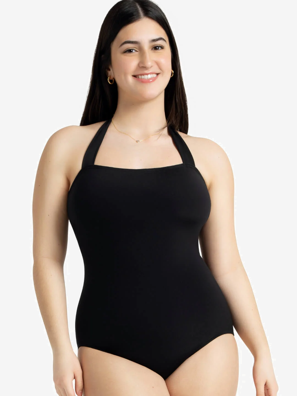 Woman wearing a black halter neck swimsuit on a light grey background